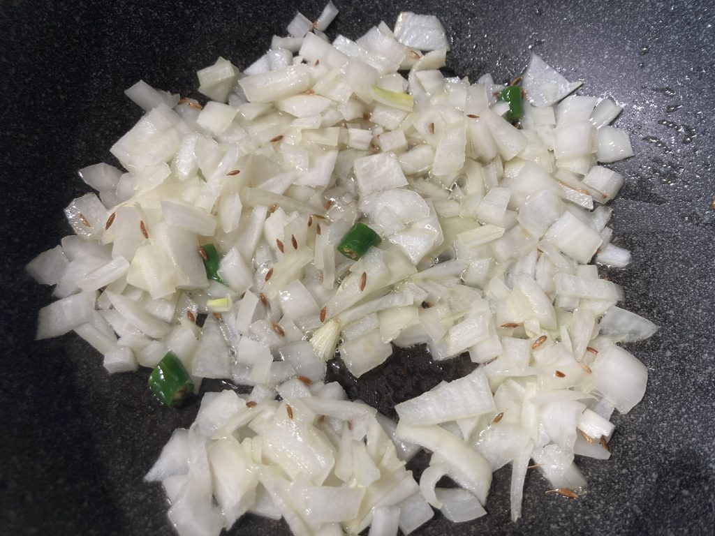 Lasooni Palak - Add onion and green chilies